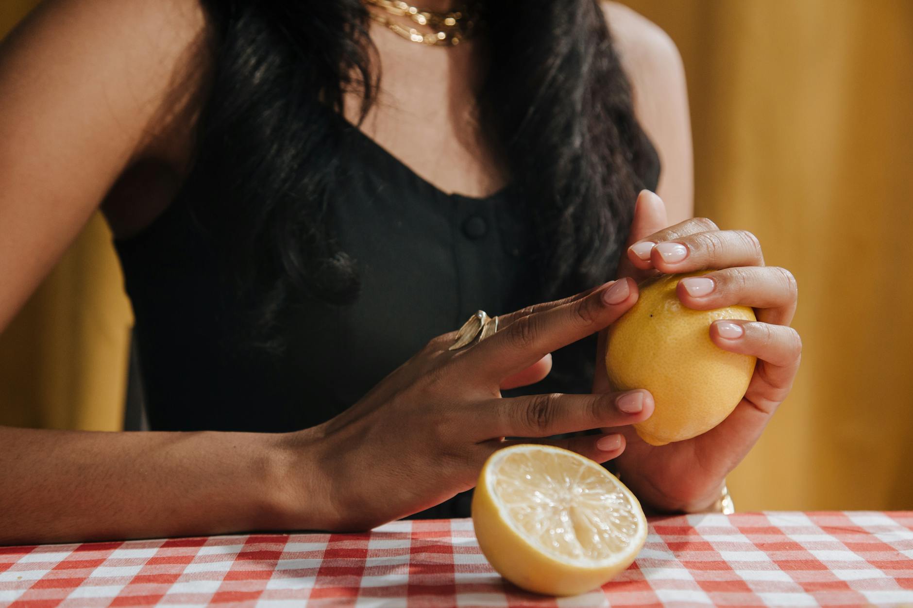 Woman holding blue and pink clitoral vibrators in contemplation, representing reclaiming pleasure after hormonal changes from IUD